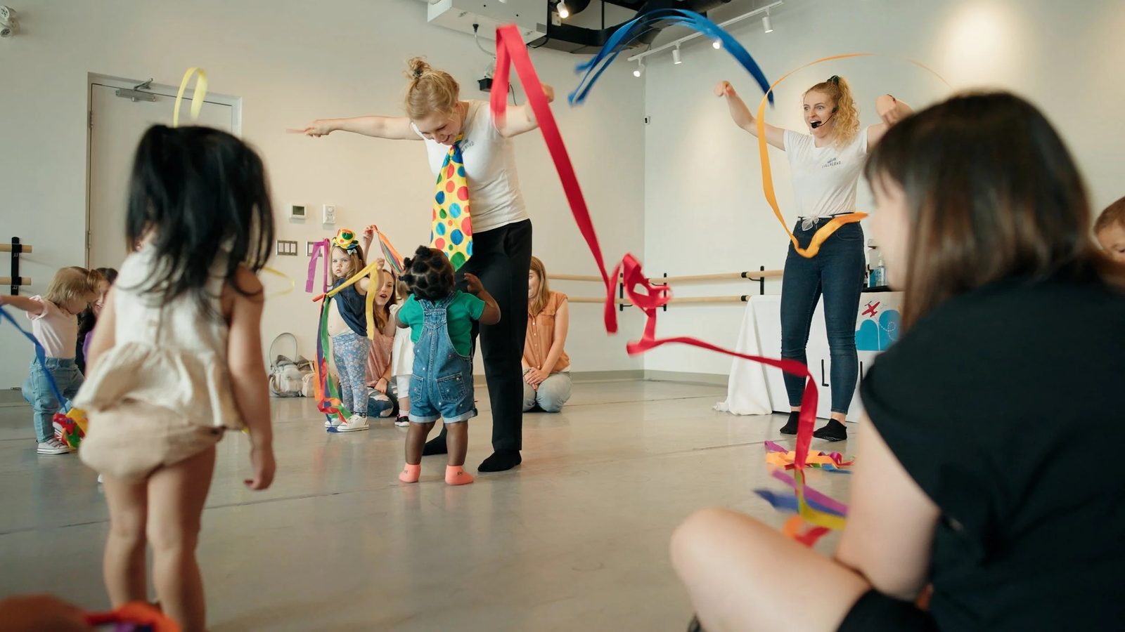 Instructors leading a sensory play class for young children at Lullaland