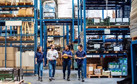 Warehouse team walking through a WHILL operations facility